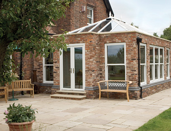 Collection of four insulated travel bottles on wooden shelf.